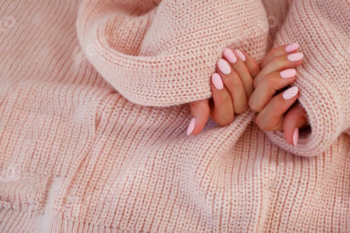 Preview: Female hands with beautiful oval-shaped nails, matte pink manicure