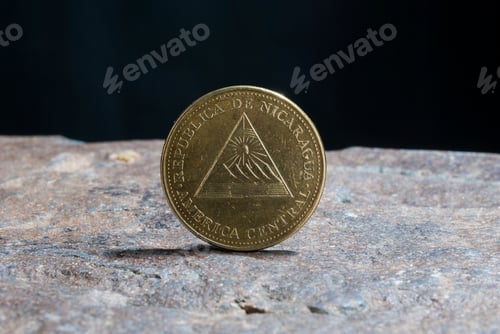 Preview: Closeup of a silver 1 Dollar 1994 Hong Kong on the rocky surface with a dark background