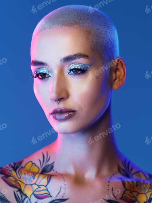 Preview: Studio shot of an attractive young woman wearing edgy makeup against a blue background