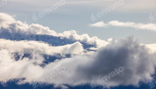 Preview: Tantalus Range covered in Snow and Clouds during Winter Season.
