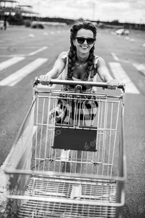 Preview: Supermarket Trolley. A Woman Is Carrying A Trolley For A Supermarket.