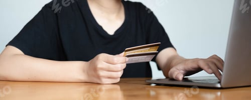 Preview: Close up woman hand using credit card and smartphone laptop for buying online shopping