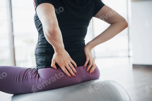 Preview: Young pregnant women sitting on the ball for exercises in the gym