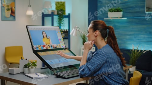 Preview: Retouch specialist doing editing work on pictures in office studio