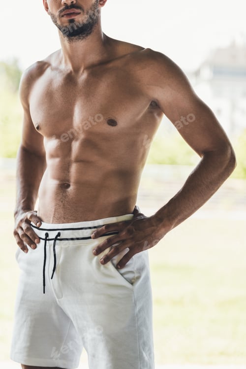 Preview: cropped shot of muscular shirtless young man