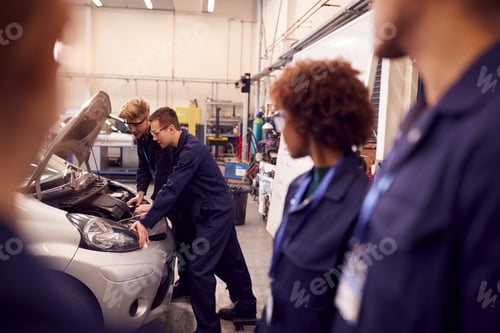Preview: Students Studying For Auto Mechanic Apprenticeship At College Working On Car Engine