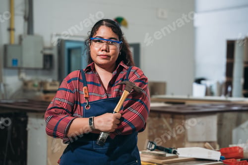 Preview: Carpenter crafting wooden furniture in a joinery workshop.