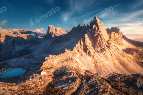 Preview: Mountains with beautiful house and church at sunset in autumn