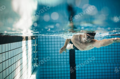 Preview: Fit young male swimmer training in the pool