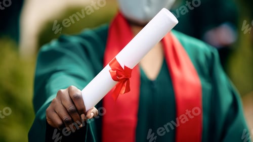 Preview: Close-up of African American graduate holding university certificate.