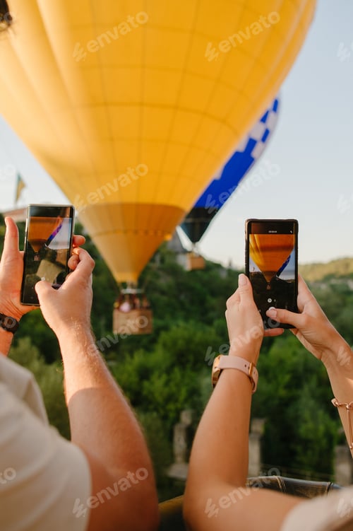 Preview: people using mobile phones while flying on hot air balloon