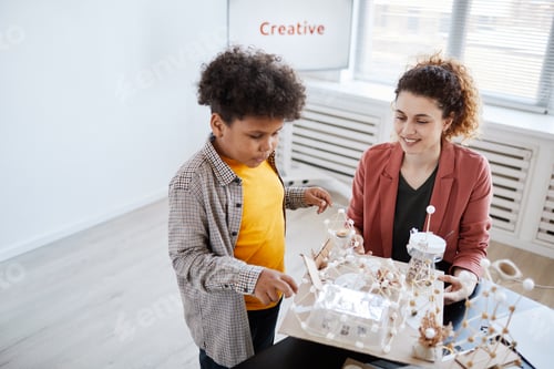 Preview: Boy Presenting Art Project in School High Angle