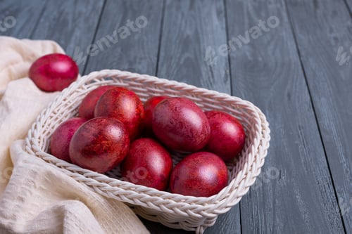 Preview: Beautiful red-orange-pink decorated traditional Easter eggs on the gray wooden background.