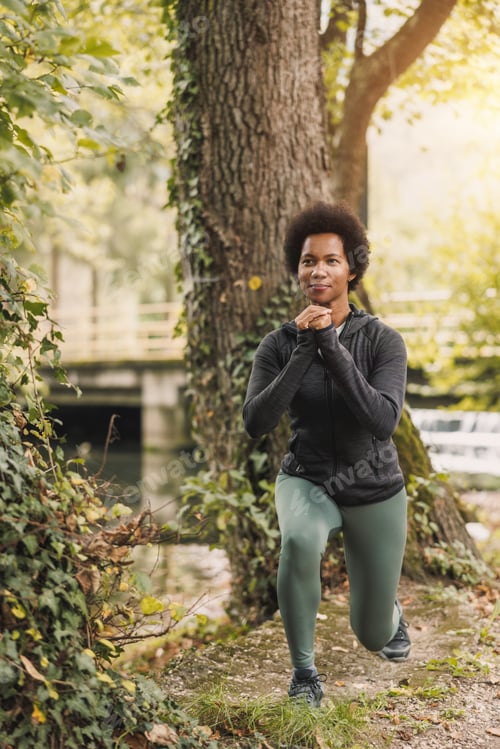 Preview: Black Woman Warming Up Before Jogging In Nature