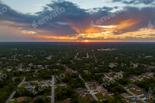 Preview: Aerial view of suburban landscape with private homes between green palm trees