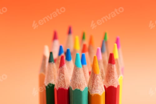 Preview: Different color pencils on coral background, closeup