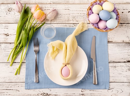 Preview: Easter eggs, bunny, tulips and cutlery top view flat lay on white rustic background