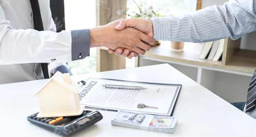Preview: Broker and client shaking hands after signing contract approved application form