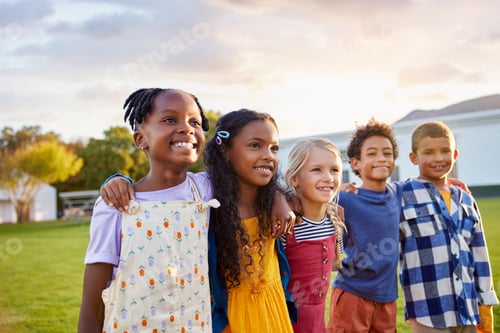 Preview: Happy multiethnic group of children hugging together at park