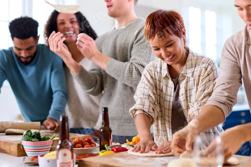 Preview: Group Of Friends At Home In Kitchen With Making Pizzas For Party Together