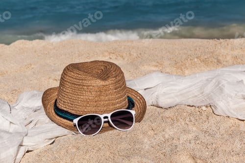 Preview: Straw hat and sunglasses on sandy beach, summer vacation concept