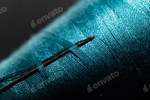 Preview: Macro shot of a Needle in a sewing thread