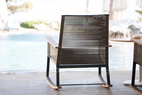 Outdoor Wicker Rocking Chair near Swimming Pool