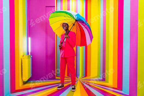 Preview: Beautiful young woman dancing and having fun inside a rainbow box room