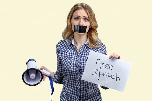 Preview: Blonde woman with taped mouth holding megaphone and banner with silence inscription.