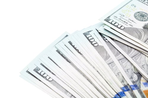 Preview: Stacks of hundred dollar bills arranged on a white surface in a neat fan display