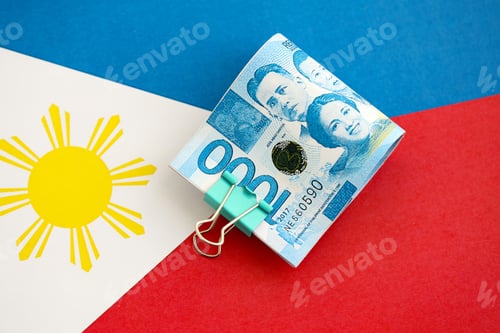 Preview: Philippines peso currency money bills lies on flag. The concept of business and investment