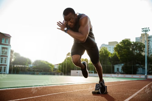 Preview: Young african runner running on racetrack
