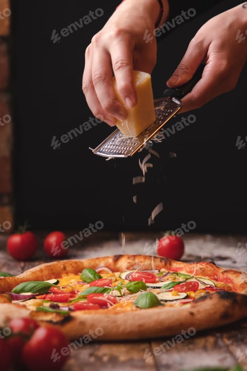 Preview: Vertical shot of a tasty and crispy pizza with vegetables and cherry tomatoes on a wooden table
