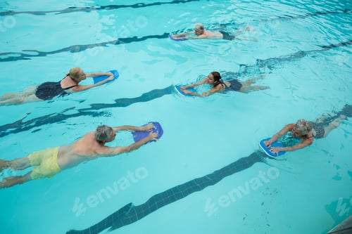 Preview: Trainer with senior swimmers swimming in pool