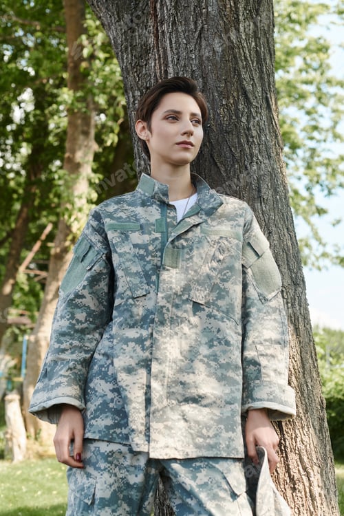 Preview: Woman in Camouflage Uniform Leaning Against Tree