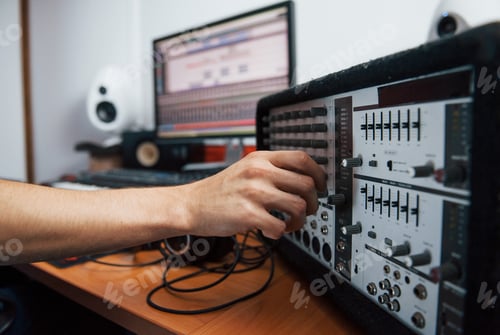Preview: Using the mixer. Sound engineer working indoors in the studio