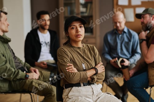 Preview: Young stressed Hispanic woman with her arms crossed on chest looking at you