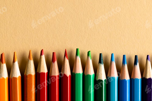 Preview: Close up of multi coloured pencils and copy space on orange background
