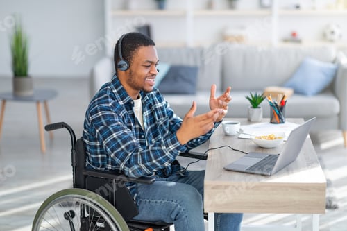 Preview: Man in Wheelchair Video Conferencing from Comfortable Home