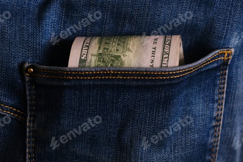 Preview: Blue jeans pocket with hundred dollars banknotes
