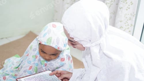 Preview: Asian Muslim families read the quran after prayers