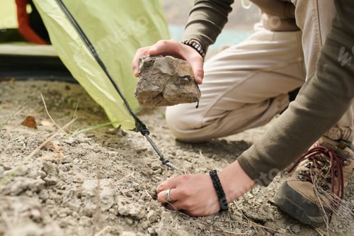 Preview: Female Traveller Setting Up Tent