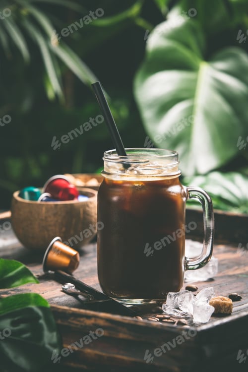 Preview: Iced coffee and tropical background, close up