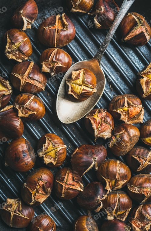Preview: Close-up of roasted chestnuts and metal vintage spoon