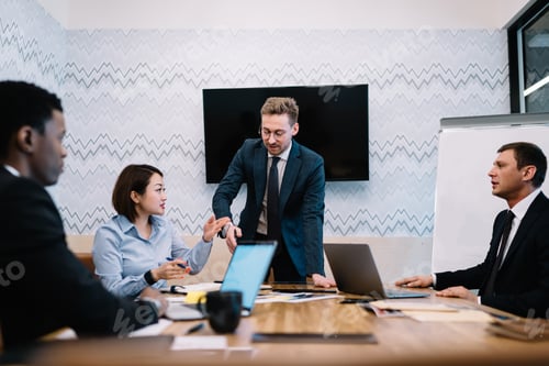 Preview: Multiethnic business partners during conference in office