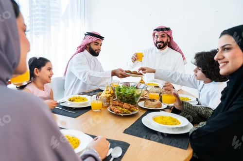 Preview: Happy arab family wearing saudi arabia clothing at home