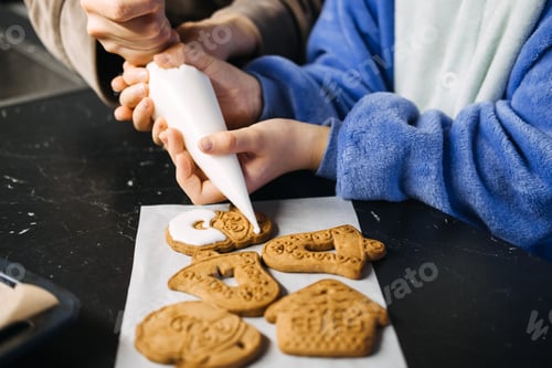 Preview: Mother and daughter decorating Christmas cookies together, holiday baking tradition, festive