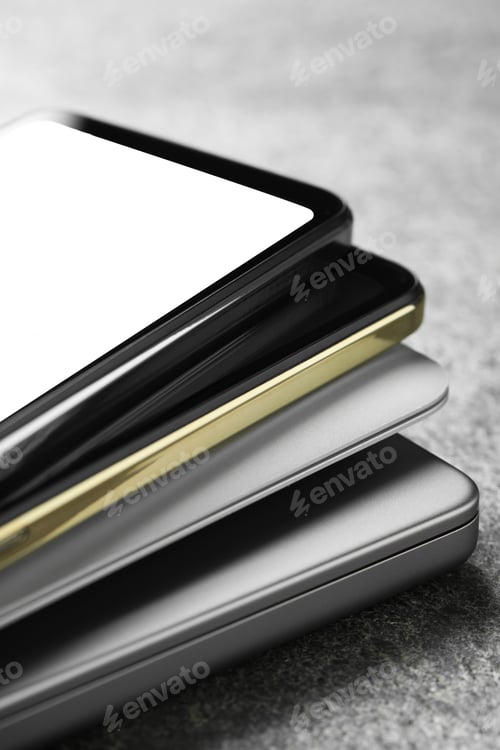 Preview: Stack of electronic devices on grey table, closeup
