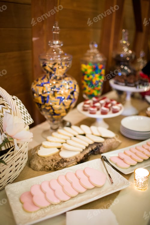 Preview: Vertical shot of sweet snacks and cookies on a table under the lights