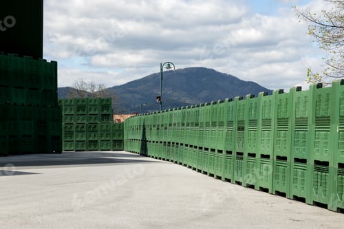 Preview: A storage area for green plastic containers for picking apples